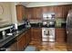 Kitchen with dark wood cabinets, granite counters, and stainless steel appliances at 26015 N 53Rd Dr, Phoenix, AZ 85083