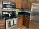 Kitchen with stainless steel appliances and dark wood cabinets at 26015 N 53Rd Dr, Phoenix, AZ 85083