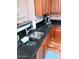 Double kitchen sink with dark granite countertop at 26015 N 53Rd Dr, Phoenix, AZ 85083