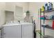 Laundry room with washer, dryer, and storage shelves at 26015 N 53Rd Dr, Phoenix, AZ 85083