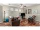 Living room with hardwood floors, brown couch, recliner, and a TV at 26015 N 53Rd Dr, Phoenix, AZ 85083