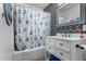 Clean bathroom with a white vanity and floral shower curtain at 2605 W Montebello Ave, Phoenix, AZ 85017