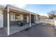 Inviting front porch with a patio table set and covered seating area at 2605 W Montebello Ave, Phoenix, AZ 85017