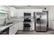 Modern kitchen featuring stainless steel appliances and white cabinetry at 2605 W Montebello Ave, Phoenix, AZ 85017