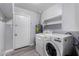 Laundry room with washer, dryer, and extra shelving at 2605 W Montebello Ave, Phoenix, AZ 85017