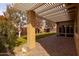 Covered patio with pavers, mature trees, and grassy area at 2702 E Saddlebrook Rd, Gilbert, AZ 85298