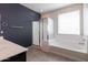 Bathroom with shower and tub, double sinks, and dark vanity at 2702 E Saddlebrook Rd, Gilbert, AZ 85298