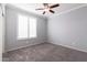 Bright bedroom with ceiling fan, window shutters, and carpet at 2702 E Saddlebrook Rd, Gilbert, AZ 85298