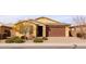 Single-story house with brown garage door and desert landscaping at 2702 E Saddlebrook Rd, Gilbert, AZ 85298