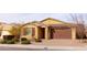 Tan house with brown garage door, landscaping, and brick driveway at 2702 E Saddlebrook Rd, Gilbert, AZ 85298