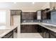 Modern kitchen with dark cabinets, granite countertops, and tile backsplash at 2702 E Saddlebrook Rd, Gilbert, AZ 85298