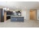 Modern kitchen with dark cabinets, granite island, and tile backsplash at 2702 E Saddlebrook Rd, Gilbert, AZ 85298