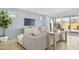 Living room with blue accent wall, modern furniture, sliding glass doors, and tile floors at 27256 N 74Th Ln, Peoria, AZ 85383