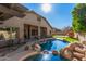 Large backyard pool with a rock waterfall and play structure at 2742 S Jacob St, Gilbert, AZ 85295