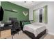 Bright bedroom with a double bed, workspace, and green accent wall at 2742 S Jacob St, Gilbert, AZ 85295