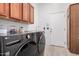 Laundry room with LG washer and dryer, and wood cabinets at 2742 S Jacob St, Gilbert, AZ 85295