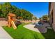 Large grassy play area with a wooden playset and a view of the pool at 2742 S Jacob St, Gilbert, AZ 85295