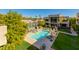 Community pool with sundeck and surrounding landscaping at 2802 E Camino Acequia Dr # 36, Phoenix, AZ 85016