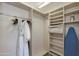 Spacious walk-in closet with shelving and hanging rods at 2802 E Camino Acequia Dr # 36, Phoenix, AZ 85016