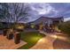 Landscaped backyard with artificial turf, seating area, and lighting at 28226 N Crook Ct, Rio Verde, AZ 85263