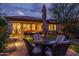 Evening view of backyard patio with seating, fire pit and lighting at 28226 N Crook Ct, Rio Verde, AZ 85263