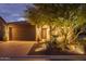 Attractive home with lighted landscaping at night at 28226 N Crook Ct, Rio Verde, AZ 85263