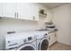 Laundry room with washer, dryer, and ample storage at 28226 N Crook Ct, Rio Verde, AZ 85263