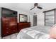 Bedroom with large dresser, barn door, and ceiling fan at 2824 S Bala Dr, Tempe, AZ 85282