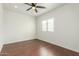 Simple bedroom with hardwood floors and ceiling fan at 28396 N Tourmaline Dr, San Tan Valley, AZ 85143