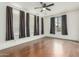 Bright bedroom with wood floors, ceiling fan, and ample window light at 28396 N Tourmaline Dr, San Tan Valley, AZ 85143