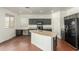 Kitchen with dark cabinets, an island, and stainless steel appliances at 28396 N Tourmaline Dr, San Tan Valley, AZ 85143