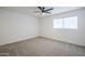 Well lit bedroom featuring ceiling fan and carpet at 3021 W Ocotillo Rd, Phoenix, AZ 85017