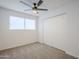 Well-lit bedroom with ceiling fan and double closet at 3021 W Ocotillo Rd, Phoenix, AZ 85017