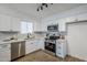 Renovated kitchen featuring white shaker cabinets and quartz counters at 3021 W Ocotillo Rd, Phoenix, AZ 85017