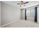 Bright bedroom with ceiling fan and carpet at 3511 E Baseline Rd # 1147, Phoenix, AZ 85042