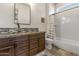 Guest bathroom with single vanity, shower/tub combo, and neutral tile at 3560 E Ironside Ln, Gilbert, AZ 85298