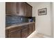 Built-in cabinetry with granite countertop and stone backsplash at 3560 E Ironside Ln, Gilbert, AZ 85298