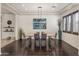 Modern dining room with dark hardwood floors and a sleek dining table at 3560 E Ironside Ln, Gilbert, AZ 85298