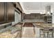 Sleek kitchen featuring granite countertops, dark cabinetry, and a large workspace at 3560 E Ironside Ln, Gilbert, AZ 85298