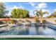 Luxury backyard oasis with a rectangular pool and waterfall feature at 3560 E Ironside Ln, Gilbert, AZ 85298