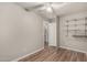 Bedroom with wood-look floors, closet shelving and access to hallway at 401 N 68Th Ave # 247, Phoenix, AZ 85043