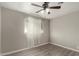 Spacious bedroom with wood-look flooring and window coverings at 401 N 68Th Ave # 247, Phoenix, AZ 85043