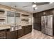 Modern kitchen with stainless steel sink and dark cabinets at 401 N 68Th Ave # 247, Phoenix, AZ 85043