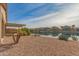 Landscaped backyard with lake view and pergola at 40861 W Little Dr, Maricopa, AZ 85138