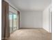 Bright bedroom with sliding glass door to a patio and neutral carpeting at 40861 W Little Dr, Maricopa, AZ 85138