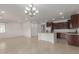 Bright dining room with chandelier and tile floor adjacent to kitchen at 40861 W Little Dr, Maricopa, AZ 85138