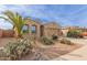 One-story house with palm trees, cacti, and a rock driveway at 40861 W Little Dr, Maricopa, AZ 85138