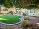 Landscaped backyard featuring artificial turf and shaded patio at 4142 E Sahuaro Dr, Phoenix, AZ 85028