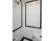 Clean shower with black and white tile and built-in bench at 4142 E Sahuaro Dr, Phoenix, AZ 85028