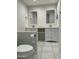 Bathroom boasts double sinks, white cabinets, and a tiled floor at 4200 N Miller Rd # 112, Scottsdale, AZ 85251